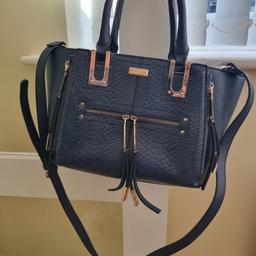 River island 
navy blue bag 
has signs of use