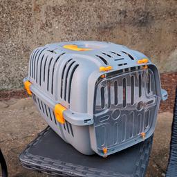 Pet hard carrier - used it for my 12lbs / 5.3kg cat and was perfect.
Dimensions: 50 x 36 x 33 cm