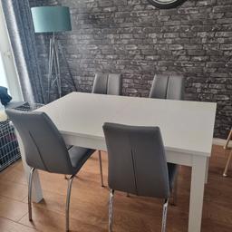 next white gloss dining table and 4 faux grey dining chairs with chrome legs.

dining table can be extended

139cm length without extension
219cm length with extension
86cm width

Good condition with usual minimal wear and tear.

collection only