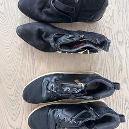 Two pairs of black shoes: trainers and boots