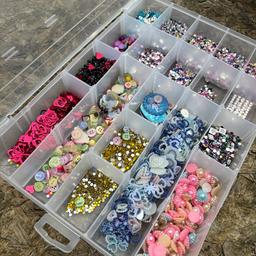 Craft box with craft goods. Large plastic box with seperate compartments and lid. Full of coloured pretty buttons and embellishments. All new not used . Great lot .