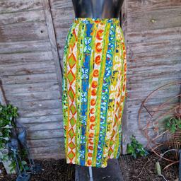 Vintage 1990s handmade maxi wrap skirt. Bright colourful zesty patterned fabric. Attached tie waist. Thread through hole on the side of waistband. Belt loops. Double layered edge. 
No labels. 
Would fit size 8 10 12 14
Length 36"