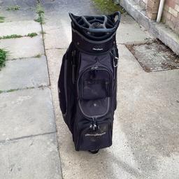 A trolley golf bag in good condition apart from some wear on the top were the putter has worn it . All zips work