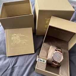 Brand new unwanted gift Burberry rose gold watch, still got original tags, and clear cover on wrist band, battery is fully working, comes with box and manual booklet. This watches are being sold for around £179.( please see advert attached for reference only)