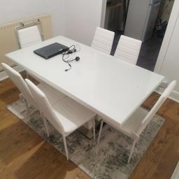 White table with glass table top and 6 white chairs. All in good condition