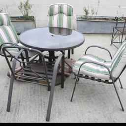 A metal garden table and four chairs set. Circular table diameter 95cm, plus a parasol.