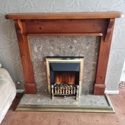 Includes:
 •Electric fire and coal.
 •Back ornamental very heavy stone.
 •Matching floor ornamental stone.
 •Fire place surrounding board (this attaches to the wall with 4 screws)
 •Brass foot cover.

The fire has two settings.