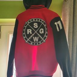 the only "real game" varsity jacket in the world of this design. size xl . with button on hood, red body black arms with proper patch stitching in white.