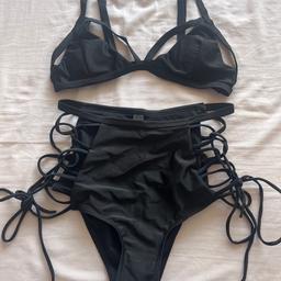 Brand new black high leg, high waisted bikini, featuring tie side briefs, and adjustable strap bikini top. Label states it is size medium but it looks quite small. Tags have been taken off but hygiene strip is still on briefs.
It was bought online, unsure of retailer as not stated on washing label.