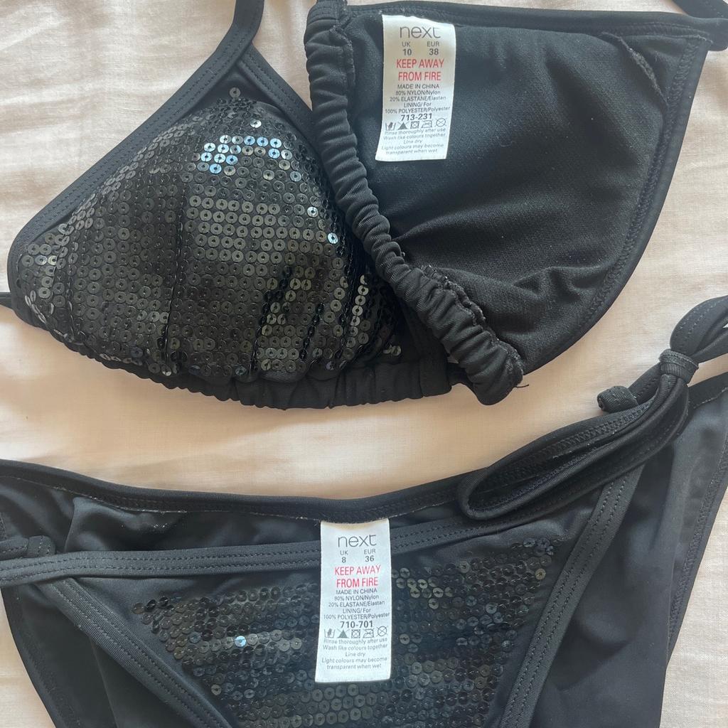 Black sequinned bikini with triangle top and tie side bottoms, by Next. Top is size 10 and bottoms size 8. Worn a few times but still in very good condition.