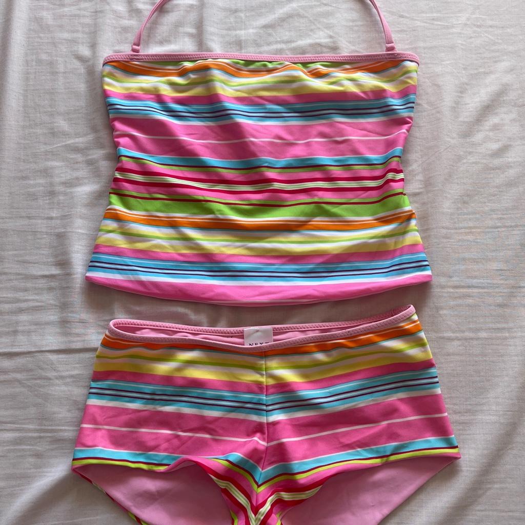 Bright striped reversible tankini, plain pink on the other side, with adjustable halter strap, size 10 by Next.
Worn a couple of times but washed and still in great condition.