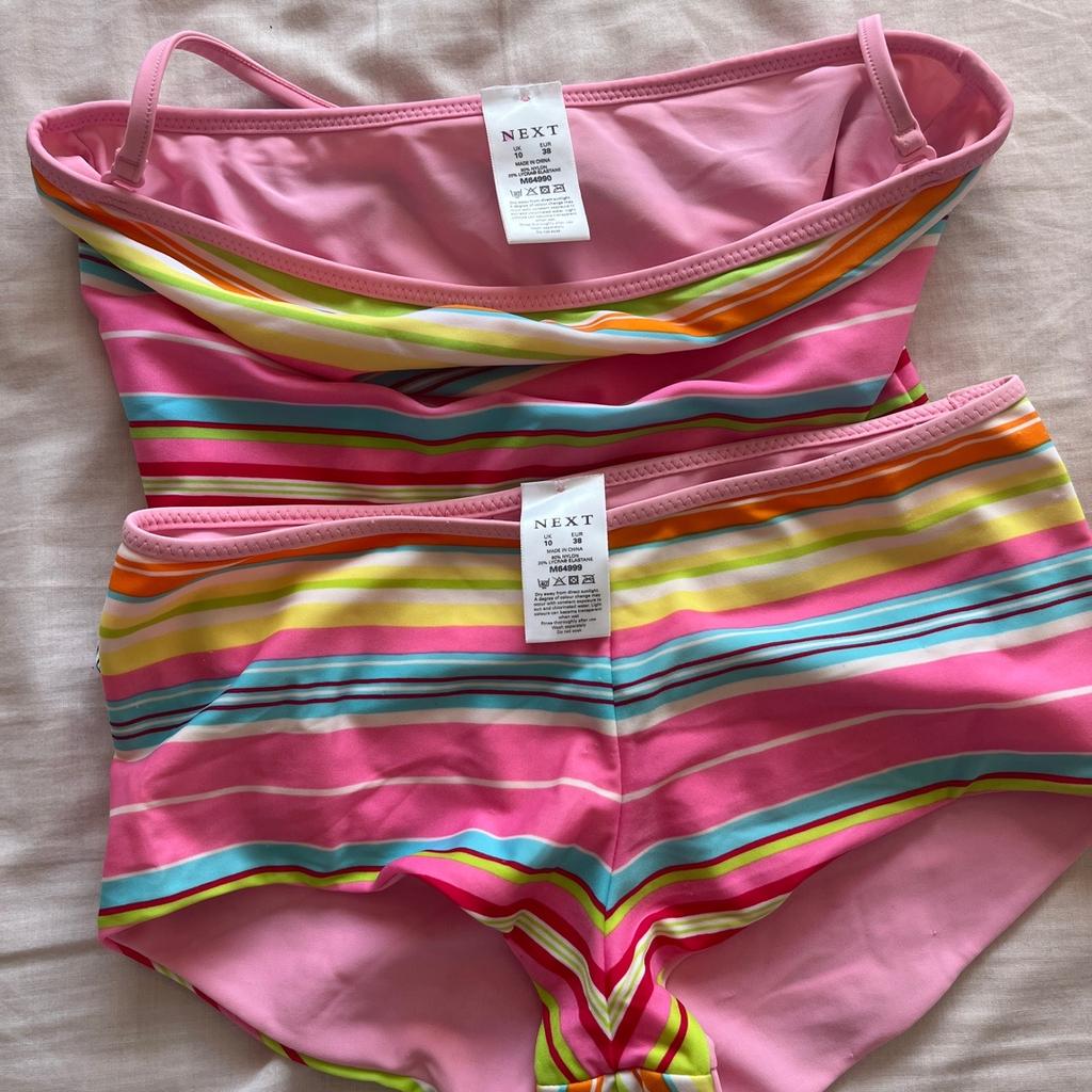 Bright striped reversible tankini, plain pink on the other side, with adjustable halter strap, size 10 by Next.
Worn a couple of times but washed and still in great condition.