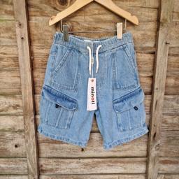 New, tagged and unworn Minotti (tkmax) aged 6-7 years cargo light blue denim shorts. Side and press stud pockets. elasticated waistband with drawstring pull through cord waist.
100% cotton