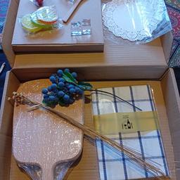beautiful new sealed cheese board gift set you get chopping board /t towel/ plate/ dollies/pickle spoon/ reusable ice cubes / decoration fruit / natural flowers There is no knifes included in this set & wasn't any make a great gift for romantic picnic or any occasion can post or combine postage