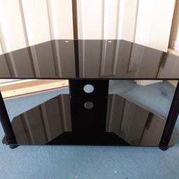 TV unit in black glass with black metal frame. As new condition. Can be collected from Skipton or Huddersfield