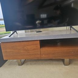 Lovely Stone grey and wood TV Stand with silver legs.
2 drawers.
(Scratches shown on image).
L 46/47inch x W20inch
Matches Display unit and Dining set currently advertised. 
Open to offers for full set.