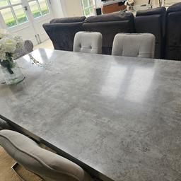Beautiful glossy stone grey dining table and 6 chairs. 
Crack which could be fixed or re furbed
Chairs need a clean. 
Silver legs. 
Set matches display unit and TV Stand. 
Happy for offers for full set.
