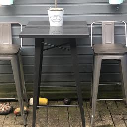Metal table plus metal stools with wooden seats