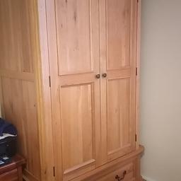 This solid natural oak wooden wardrobe comes with and hanging rail inside aswell as a drawer at the bottom. It has double doors also, you can store things on top of the wardrobe as it has storage space this is like new not really used it. The price is negotiable