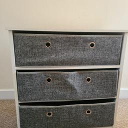 white wooden drawers with grey canvass inserts.
