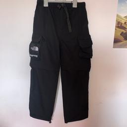 picked these up a couple of months ago and don’t really suit me so i’m just looking to sell these for a bit of cash, mens supreme x northface large black cargo trousers, can unzip legs to turn to shorts good for festivals and summer