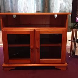 A wooden TV unit with 3 shelves, 2 glass doors. Width 85cm, Height 75cm, Depth 48cm.