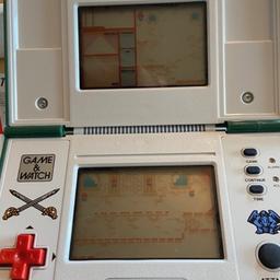 Take a trip down memory lane with this vintage Handheld Nintendo Game & Watch Zelda ZL-65 Multi-Screen from 1989 Japan. The device has been meticulously maintained and is in excellent working order. It is a rare collectable item that will transport you back to the 1980s, with its unique features and design. The game was manufactured in Japan and is a must-have for retro gaming enthusiasts. Get your hands on this gem and relive the nostalgia of the gaming era.