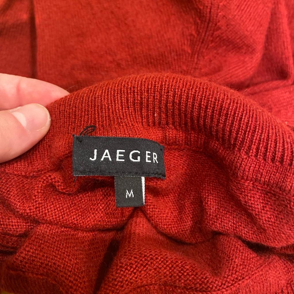 Red Jaeger Merino Polo Neck Sweater - Ladies Medium, Pristine Condition

In perfect condition, barely worn, no flaws that I can see.

Would fit UK10-14

Elevate your spring wardrobe with this stunning red Jaeger Merino polo neck sweater. Crafted from a luxurious blend of cashmere and wool, this relaxed fit jumper features a tight-knit pattern and long sleeves for ultimate comfort.

Perfect for both casual wear and a professional setting, it's ideal for the modern woman who values style and comfort.

The elegant roll neck and pullover style of this sweater, combined with its lightweight and stretchy fabric, make it a versatile addition to any wardrobe.

Its classic design and vibrant red colour make it perfect for those who appreciate a touch of 80s or 90s fashion, while its pristine quality ensures that it will last for many seasons to come.