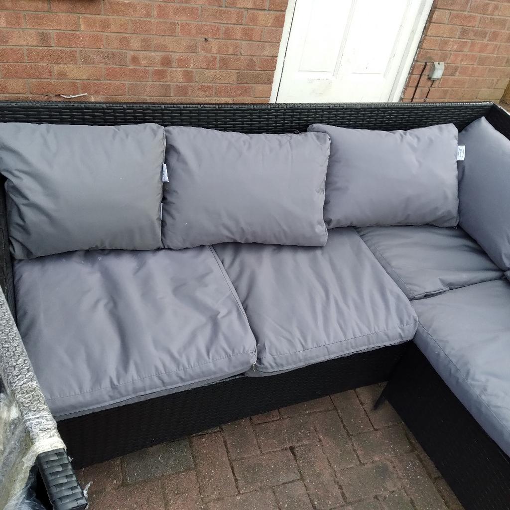 rattan garden set in good condition comes with cushons and brand new table glass is black