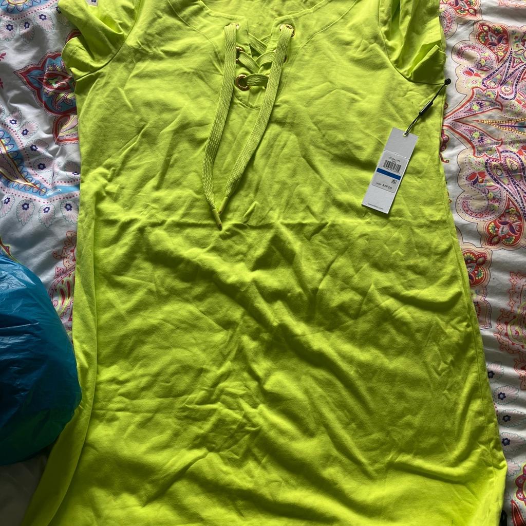 Here in selling this neon green Calvin klein dress new with tags size xl I would say 12/14 uk please take a look at my other stuff any questions please ask thankyou x