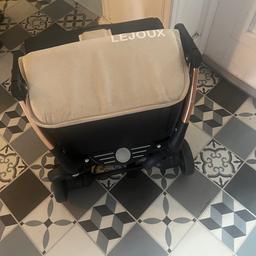 lejoux stroller in good condition only used once for travel . Includes rain cover and mosquito net .