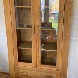 Sold wood cabinet with glass doors and two draws 
As shown in picture two stains but doesn’t affect  the use. 
Smoke pet free home