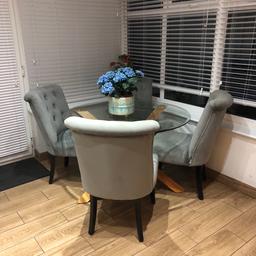 Round glass table with 4 grey chairs immaculate condition pick up only