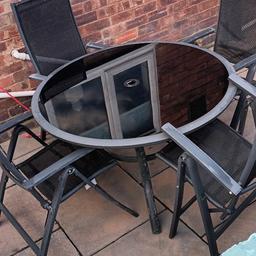 glass top round table with 4 woven recliner chairs