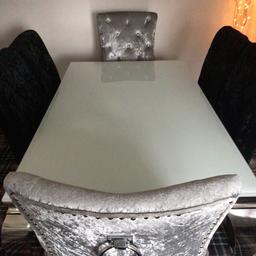 Excellent condition BARGAIN ..Next white glass top table with chrome legs length 160 cm width 90 cm height 74 cm 2 silver coloured chairs and 4 black chairs also in Excellent condition..smoke free home moving hence sale Hardly been used  Collection and Cash only no transfers etc Thanks