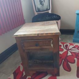 Lovely solid wood lamp table with drawer at the top . Bluey tones within the wood . Lovely condition of the table bought from Wayfair. Smoke free home . Cost £100 originally. Look nice in a living room or hallway. Height is 19 inches x width 14 inches and depth is 14 inches.