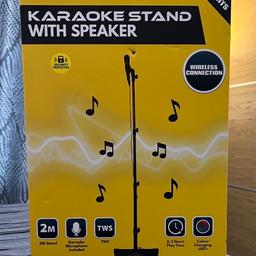 A brand new karaoke speaker and mic with stand never been used
