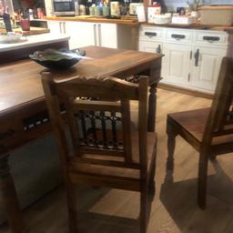 Solid wood large dining table , very heavy with metal inlay on tables and six chairs . Damage on one chair leg but solid now . Otherwise in good condition.