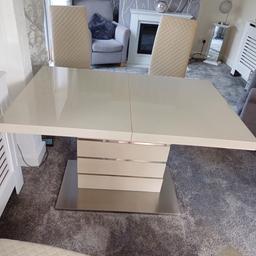 Extending dining tale and 4 chairs 
Closed 120cm long x 80cm wide x 76cm high
Open 160cm long.
Cream and stainless steel with faux leather chairs. 
Some signs of wear on the chairs and 2 small chips on the table one on the top and one on the pedestal base. Solid table cost £800 new approx 4 yrs old