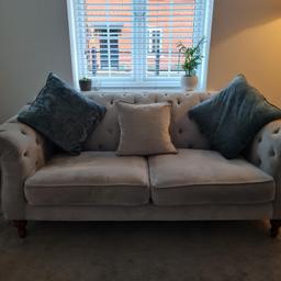 Chesterfield style Light Grey 3 seater sofa DFS

Chesterfield style light grey 3 seater sofa from DFS with cushions included. Good condition. Some material has pulled away from one button, (as one of the photos has shown) but this can be covered up by the middle cushion.
Sofa Dimensions:
Length: 200 cm
Height: 80 cm
Depth: 100 cm
Seat Dimensions:
70 cm x 60 cm per seat cushion