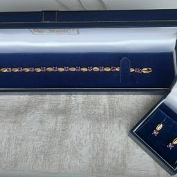 Absolutely stunning 8.3 g hallmarked nine carat 375 gold and amethyst f long, containing 15 amethysts plus one in each earring. Presented in beautiful, matching gift boxes. Any questions please ask.