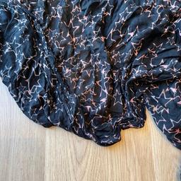 Polyester 
Black star print scarf with orange stars one side and orange/pink stars the other. 
Excellent condition