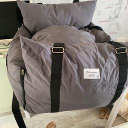 This bed is amazing it's a booster seat my dog slept in it the whole way in hoilday it straps in easy and the front can open up I had mine in the front seat their a lead to attach to collar for extra safety it's brilliant really padded I'd say a French bulldog , spaniel , cost me 150.00 in the sale