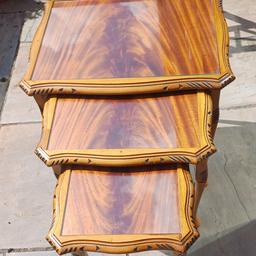 3 beautiful wooden tables with glass tops and Cabriole legs Mahogany. The tables slide into each other on rails rather than sitting on top of  Slight scratch to top glass but not noticeable. Beautifully carved. Collection SK1