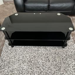 For sale 
Black glass tv stand with 3 shelves 105cm at the widest point 75cm at the back depth 45cm height 47cm. As new condition. Collection from Sheffield