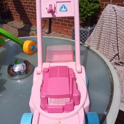 childs toy lawnmower with tiny balls that swirl round when pushed