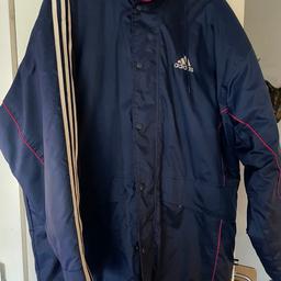 Fleece lined zip pockets. One inside fold away hood 3 white stripes down the shoulders