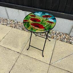 Lovely outdoor/indoor small side table with glass top featuring poppies. In lovely condition. 
Collection only.