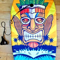 Surf Foam Bodyboard Orange Yellow  Blue Black with printed tiki head picture 
width 46cm
length 82cm 
with ankle strap with velcro 
Perfect for any age trying Body surfing 
Light weight
Pre-owned previously used item still good condition 

Cash on Collection Cannock Area
