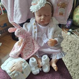 Soft bodied sleeping baby Doll.. 
cloth body with soft vinyl limbs..
no marks or damage to doll but hair is very wispy with not much at the back..
Head and limbs are posable..
She's wearing a new dress with pants, nappies included.. a cardigan new baby booties, and rabbit comforter..
25.00 sorry no offers
